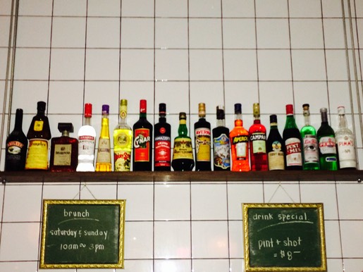 Bottles of Italian liquor on a shelf.